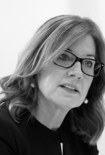 A black & white close-up photo of Elizabeth Denham CBE, looking to the right of the camera.