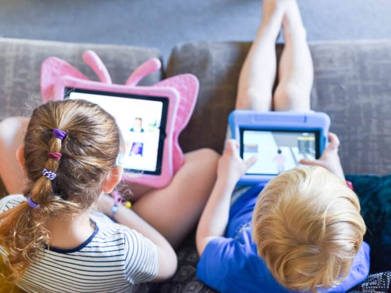 Children using their tablet device to play computer games and use educational apps.