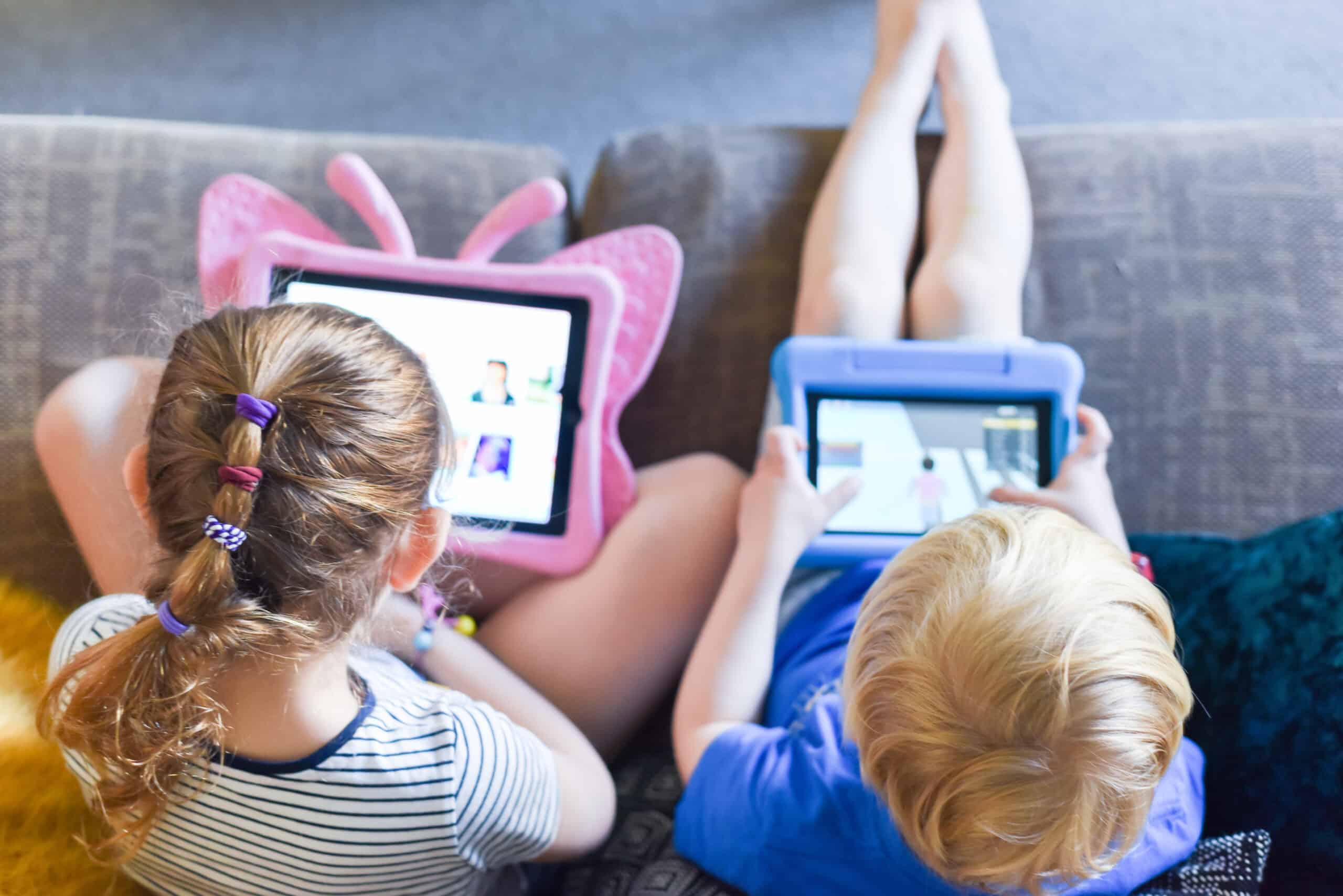 Children using their tablet device to play computer games and use educational apps.