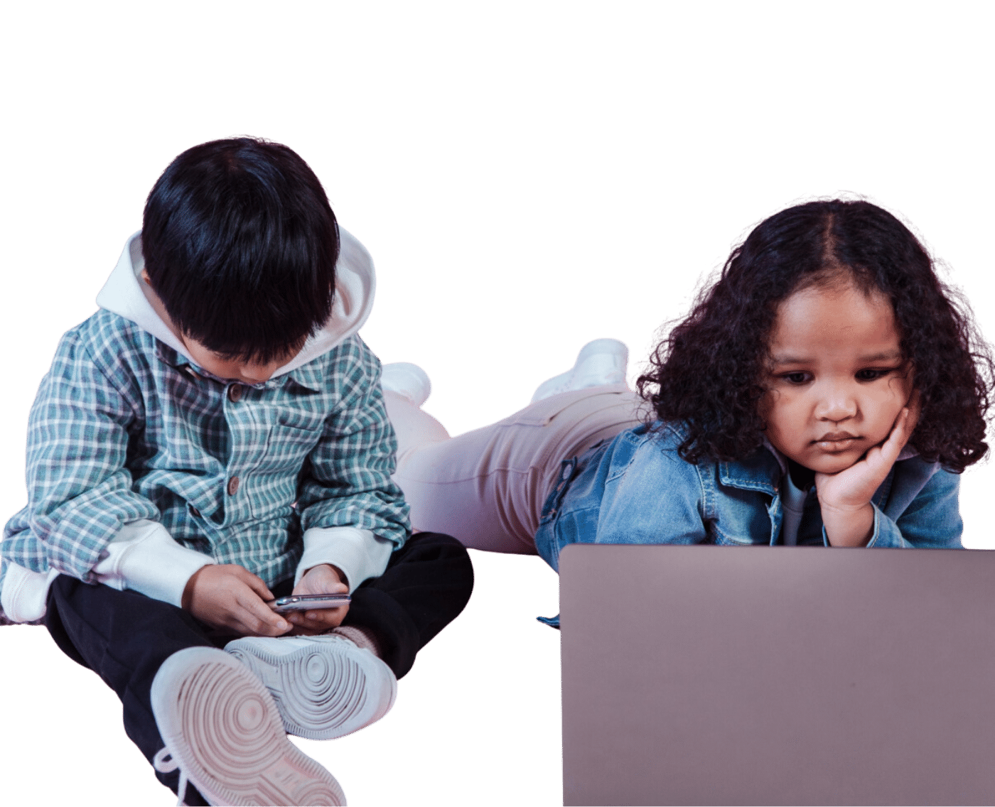 Two children are laying down on the floor staring at their respective devices.