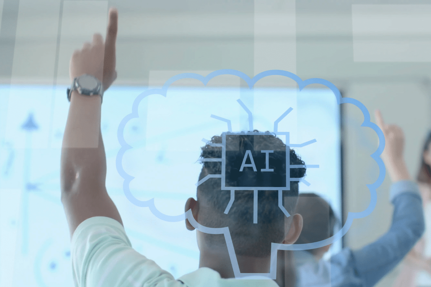 A mixed raced teen boy has back turned to the camera, with his left hand raised in the area. He is wearing a light mint green polo. He appears to be in a learning environment, like a school. In between the camera and the room is a glass pane that has a speech mark icon in a light gray colour, with "AI" in the middle.