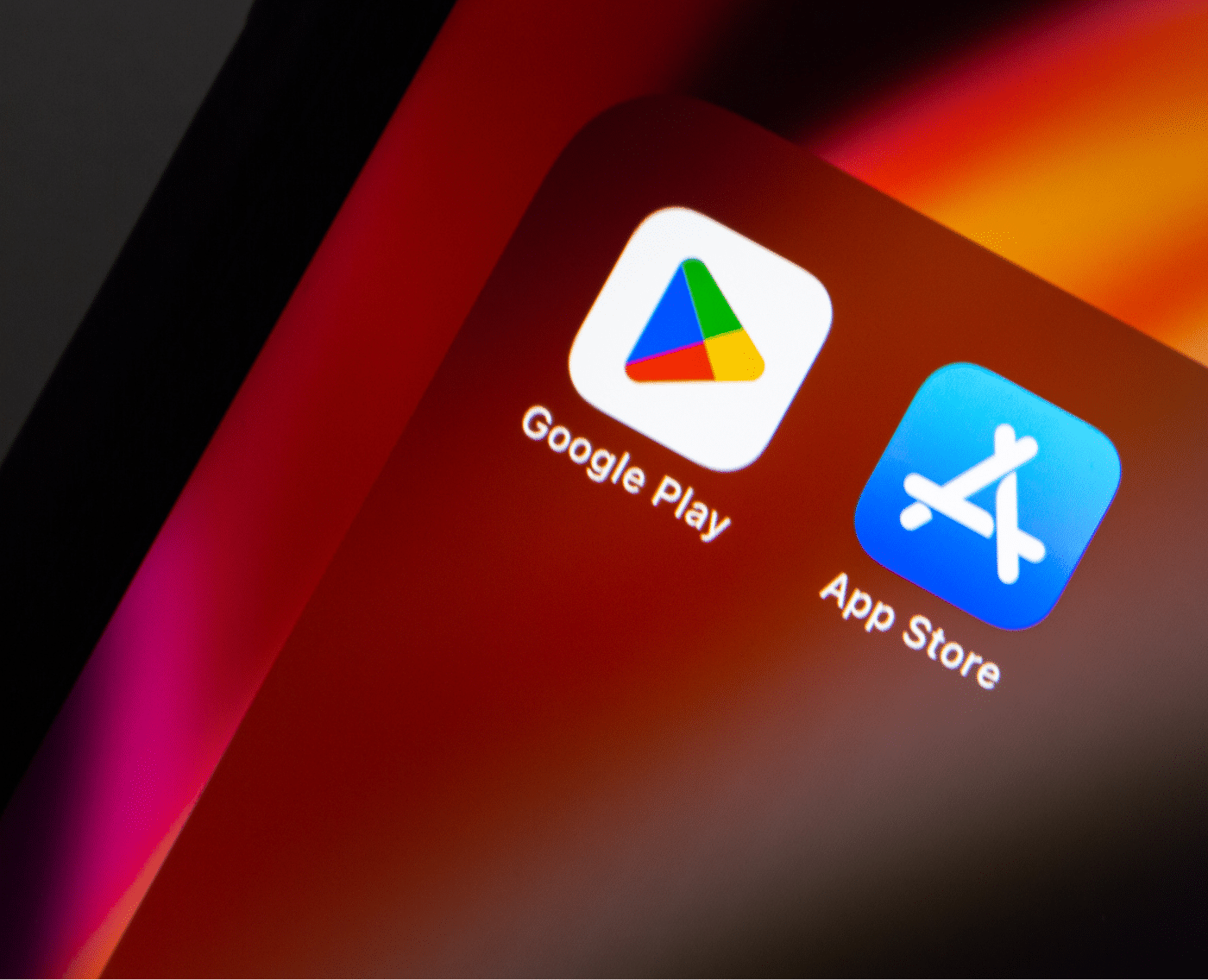 A smartphone screen showing the Google Play and App Store icons side by side on a red-orange gradient background. 