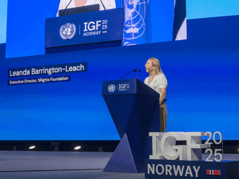 Leanda Barrington-Leach, Executive Director of 5Rights Foundation, delivers the opening remarks at a high-level ministerial panel during the 2025 UN Internet Governance Forum in Norway. She stands at the podium beneath the IGF and UN insignia.