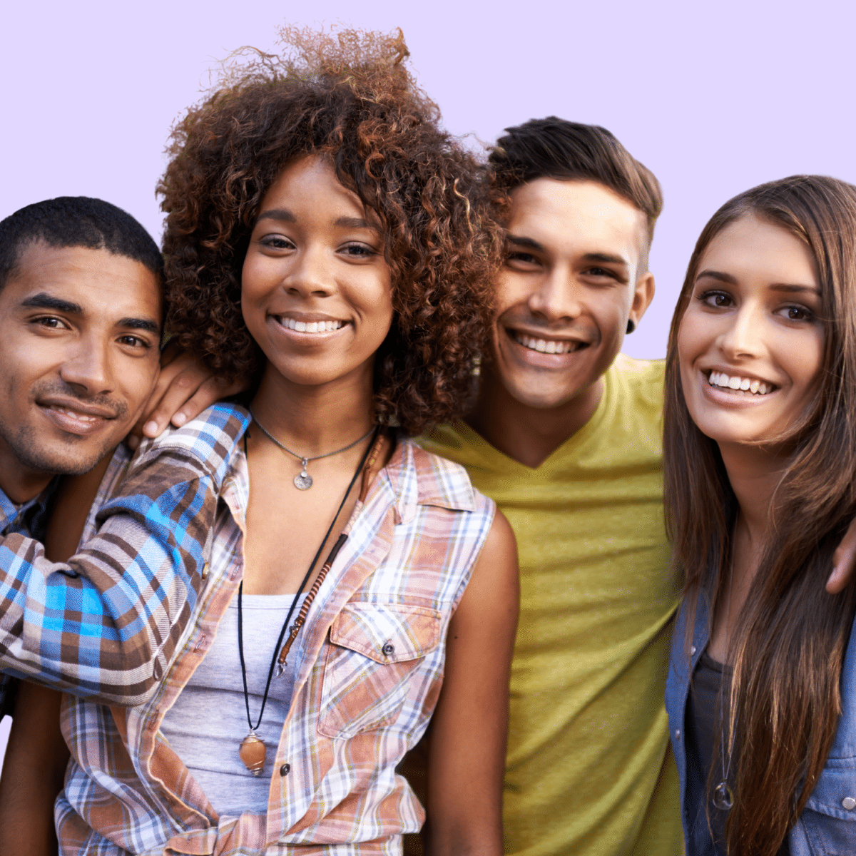 Group of 4 young people standing together, smiling.