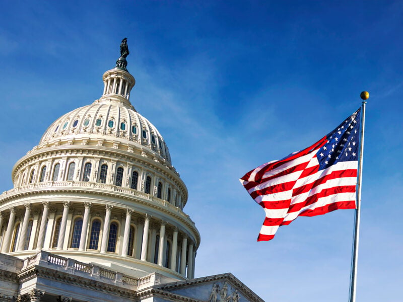 American flag waving with the Capitol Hill